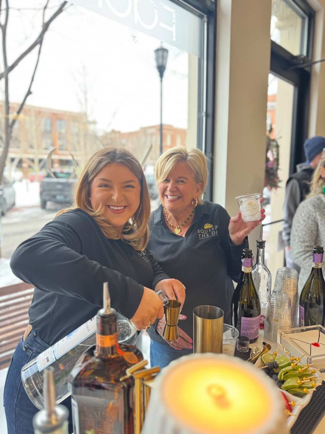 Linda and Kenzie pouring drinks at a styled event
