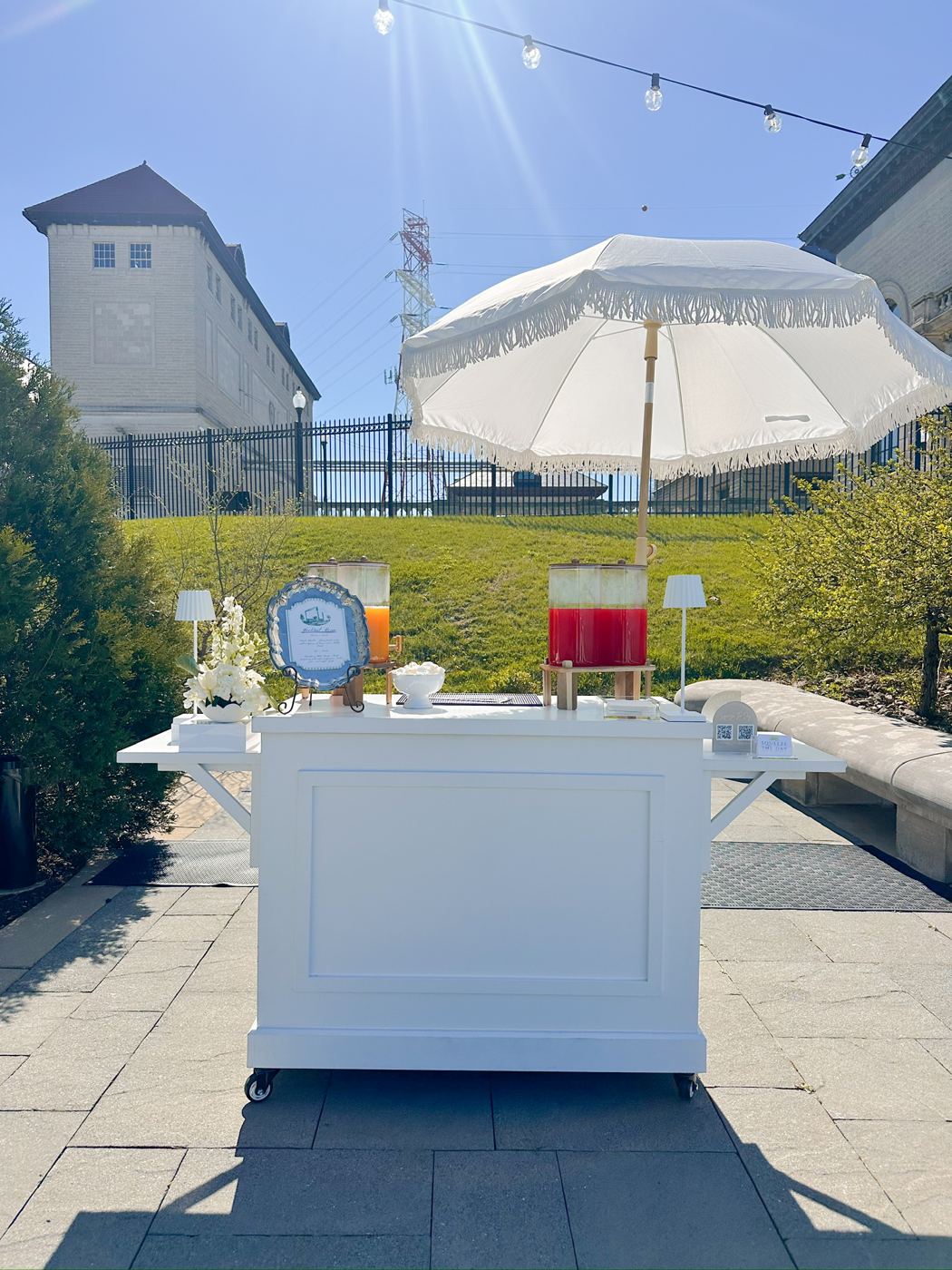 Full styled bar on a patio with string lights